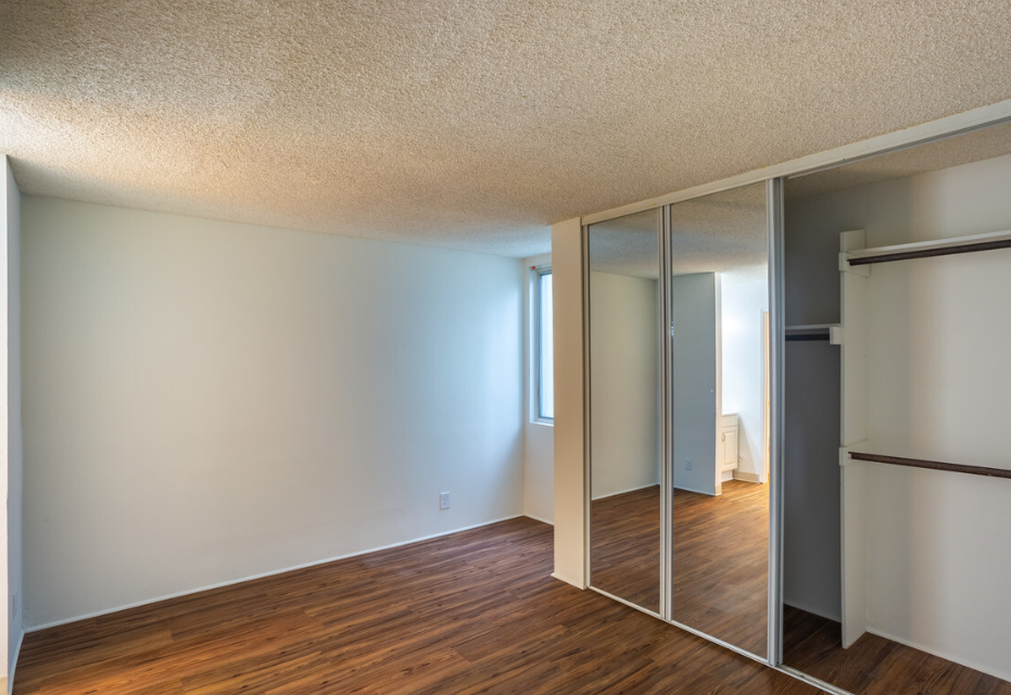 Windward Village Apartments unfurnished room with mirror closet Windward Village Apartments unfurnished room with mirror closet